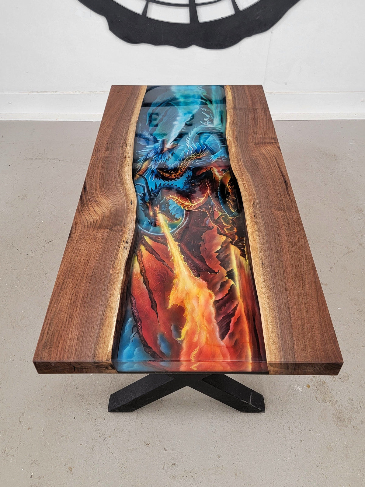 Custom walnut table with epoxy covering a handmade airbrush design of two dragons spitting fire and ice