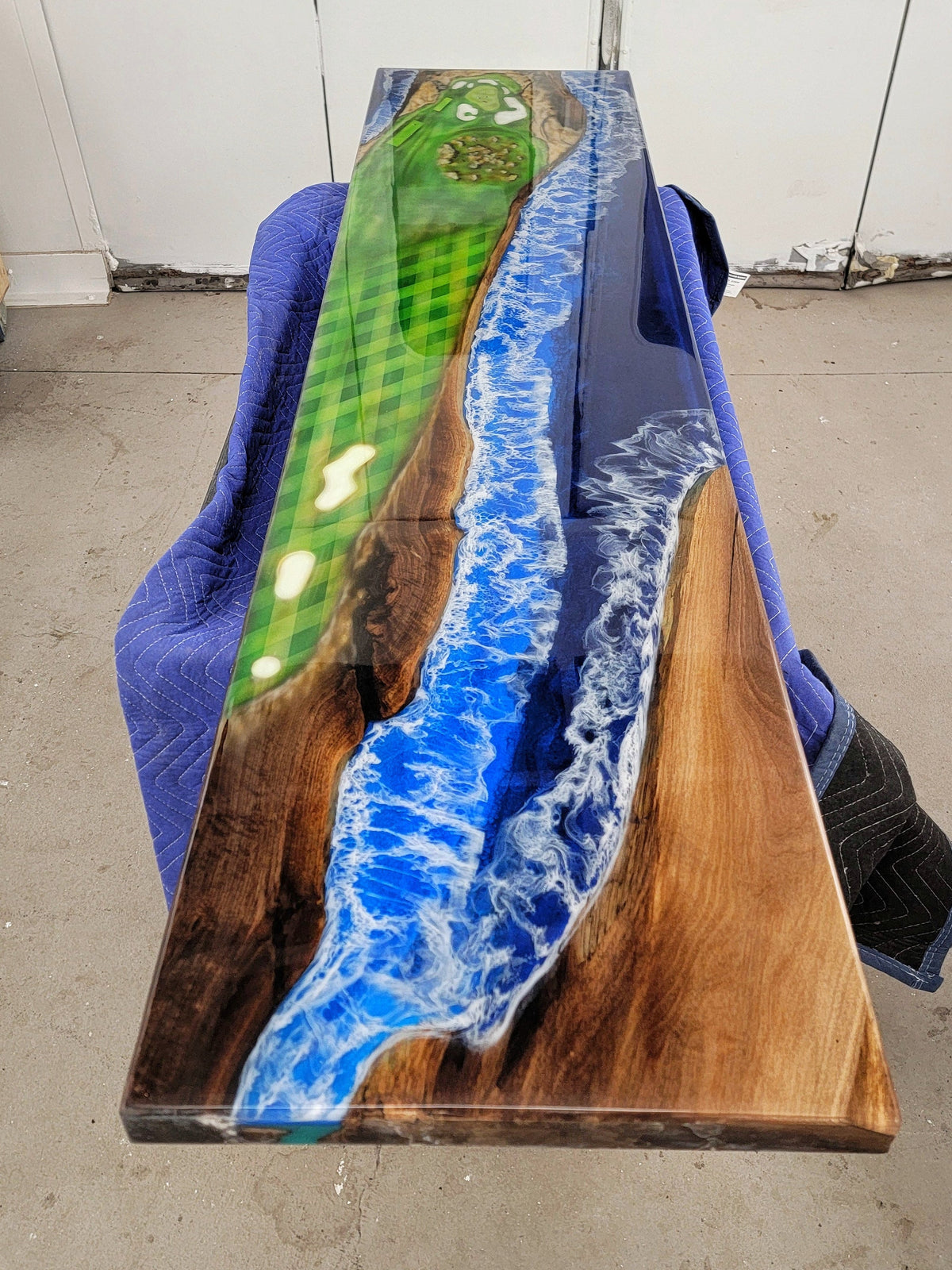 Wooden bartop with airbrushed golf course and ocean style epoxy made by Backyard Resin
