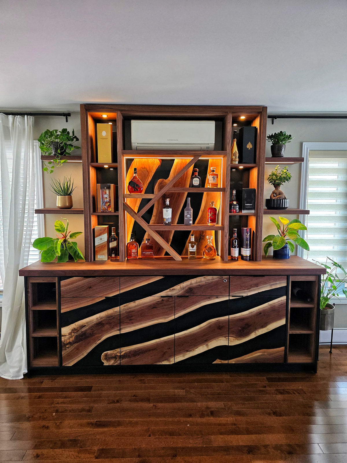 Custom wooden bar cabinet with offset shelves, wood and epoxy door fronts, LED lighting, thumbprint activated drawer, soft-close drawers by Backyard Resin.