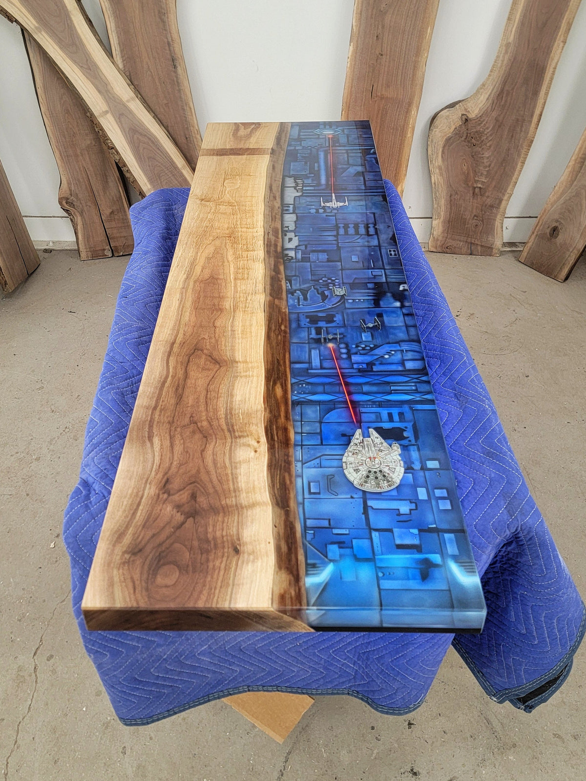 Walnut and epoxy bartop airbrushed with Star Wars trench and Star Wars figurines (Millenium falcon, tie fighters, xwings)