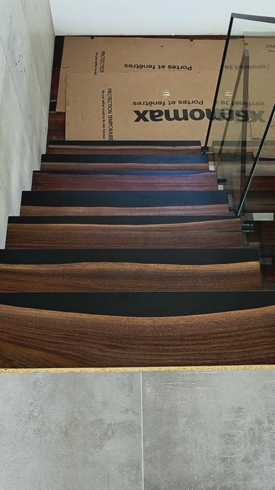 Video of a custom installation of wood and epoxy stairs, lit up with integrated LED lighting